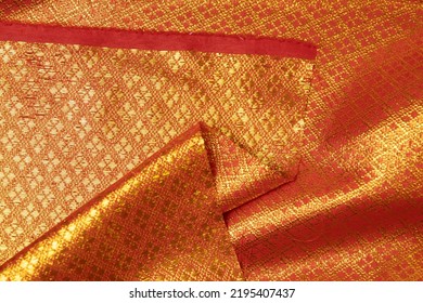 Folded Red-colored Fabric Texture Background. This Brocade Fabric Is Made Of Polyester.