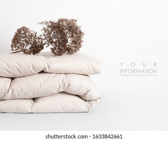 Folded Soft White Duvet, Blanket Or Bedspread, Against White Background. Close Up Photo