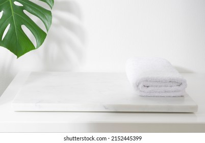 Folded Spa Towel On White Marble Podium For Product Display