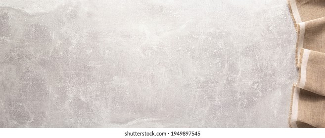 Folded Tablecloth At Stone Or Marble Surface Of Table. Top View As Panorama Of Cloth Napkin Texture Background With Copy Space