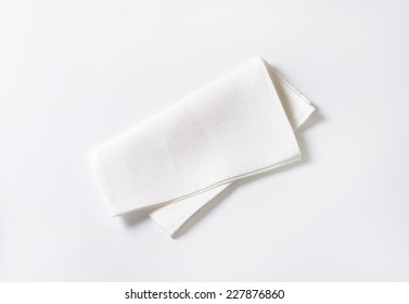 folded white napkin on white background