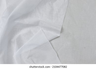 Folded White-colored Cheese Cloth Fabric Texture Background. This Is Made Of Cotton.