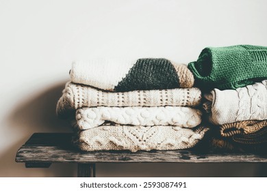 Folded winter sweaters on a wooden shelf - Powered by Shutterstock - Get 15% off with code: PIKWIZARD15