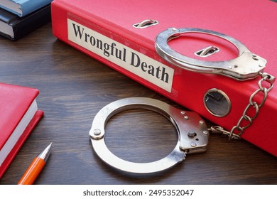 Folder about wrongful death and handcuffs.