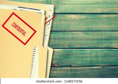 Folder With Confidential Papers On Table