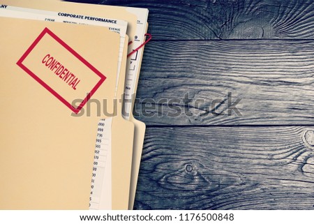 Folder with confidential papers on table