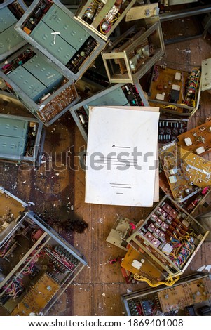 Folder for documents on the background of parts of old electronic devices. White paper cover with empty text fields. Perfect for design.