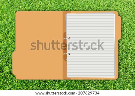 folder with documents on green grass background