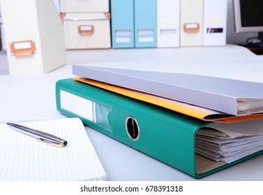 Folder File, Note And Pen On The Desk. Blurred Background.