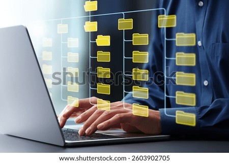 Folder hierarchy structure and document management system DMS. Businessman using laptop computer for saving and classifying files.
