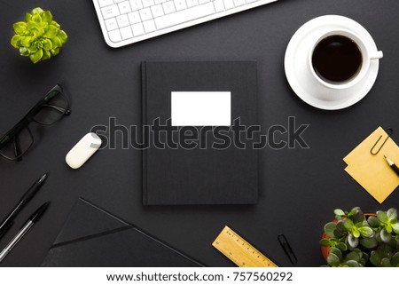 Folder With Label Surrounded By Office Supplies On Gray Desk