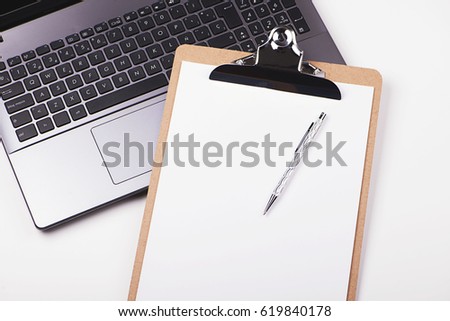 Folder with sheets on laptop keyboard. Horizontal shoot.