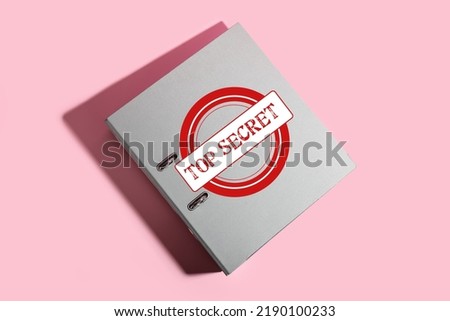 Folder with top secret documents on pink background
