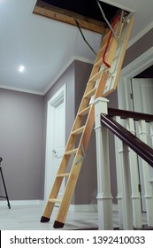 Folding Attic Ladder. Wooden Pull Down Attic Folding Stairs In Small Hallway, Space Saving In Home Concept