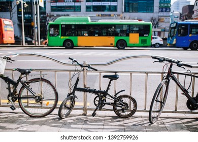 Folding Bicycle Parking Beside Road With Public Transport Bus In Background 
In Seoul, South Korea.