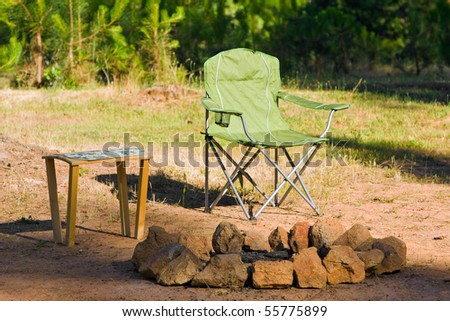 Folding Chair and Table next to a Fire Ring.