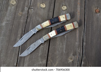 Folding knife or dagger with damascus blade, bone and horn grip