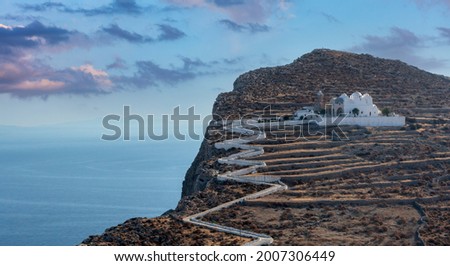 Folegandros island, Greece, Cyclades. Panagia Virgin Mary Church and long zigzag road aerial drone view. Traditional cycladic whitewashed church on top of a steep hill overlooking Chora and Aegean Sea Foto stock © 