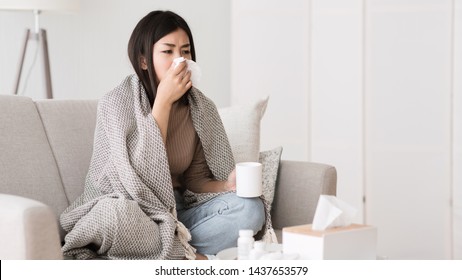 Folk Medicine. Sick Girl With Fever Wrapped In Blanket Drinking Hot Tea And Blowing Nose, Free Space