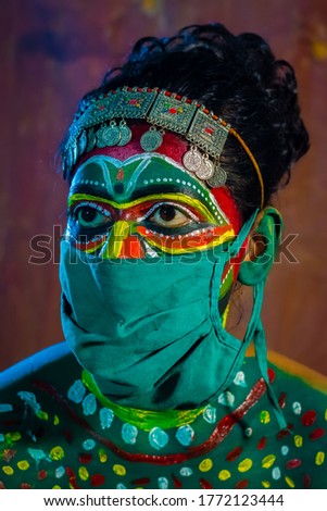  A folk theater artist putting colorful make-up
