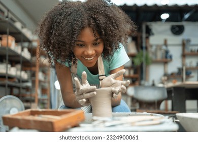 Follow the girl's journey of sculpting dreams in the ceramic workshop, where she shapes and refines clay with passion, creating unique and enchanting pieces. - Powered by Shutterstock