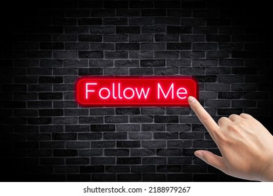 Follow me banner button with a hand on brick wall background. - Powered by Shutterstock