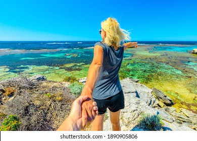 Follow me, girl holding hand at above promontory of Jeannies Lookout at Rottnest Island, Western Australia. Tourism in Perth, Australia. Concept of summer holidays and travel, holding man by hand. - Shutterstock ID 1890905806