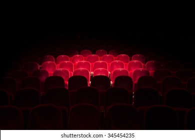 Follow spot on red seat in a generic theater