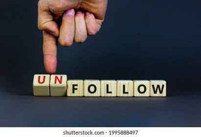 Follow or unfollow symbol. Businessman turns wooden cubes and changes words follow to unfollow. Beautiful grey background, copy space. Business and follow or unfollow concept.