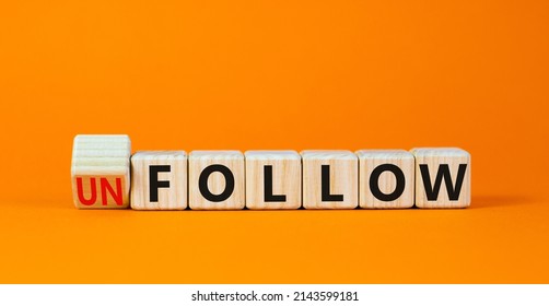 Follow or unfollow symbol. Turned wooden cubes and changed concept words Follow to Unfollow. Beautiful orange table orange background. Business and follow or unfollow concept. Copy space.