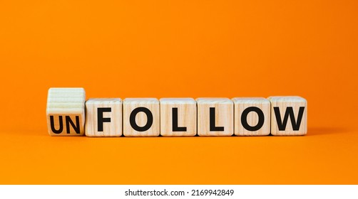 Follow or unfollow symbol. Turned wooden cubes and changed concept words Follow to Unfollow. Beautiful orange table orange background. Business and follow or unfollow concept. Copy space.