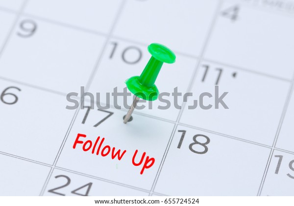 Follow Up written on  a calendar\
with a green push pin to remind you and important appointment.\
