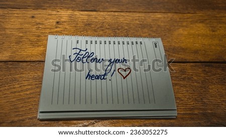 Follow your heart, writing love text on paper, lovely message. Text on spiral agenda. Romantic, love concept. Valentine`s day.