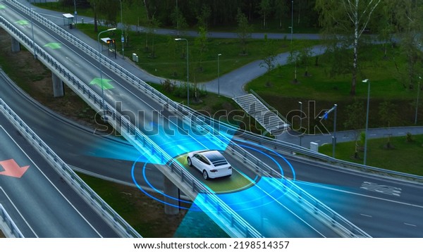 Following Aerial Drone View: Autonomous Self\
Driving Car Moving Through Megapolis City Highway. Visualization\
Concept: Sensor Scanning Road Ahead for Vehicles, Speed Limits.\
Day, Driveway.
