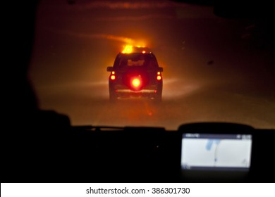 Following Car Convoy In Norwegian Mountain Night Blizzard