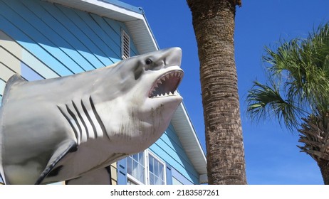 Folly Beach, South Carolina USA July 27, 2022: Large Plastic Great White Shark Decorating Surf Shop Along  Row Of Commercial Buildings.