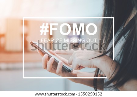 FOMO, fear of missing out concept. Close-up image of woman hand using mobile smartphone