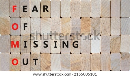 FOMO fear of missing out symbol. Concept words FOMO fear of missing out on wooden blocks on beautiful wooden background. Business FOMO fear of missing out concept. Copy space.