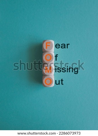 FOMO fear of missing out symbol. Concept words FOMO fear of missing out on wooden cubes on beautiful blue background. Business FOMO fear of missing out concept. Copy space.