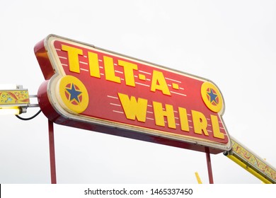 Fond Du Lac, Wisconsin / USA - July 20, 2019 : Lighted Sign For The Popular Tilt A Whirl Thrill Amusement Ride At A County Fair