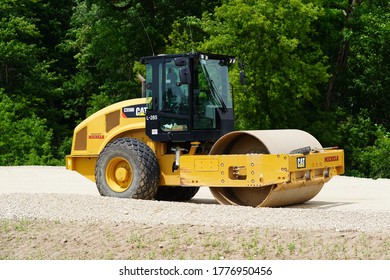 Fond du Lac, Wisconsin / USA - July 14th, 2020: Caterpillar steamroller sits and waits to be used to flatten out the constructed land surface to expand highway 23 from fond du lac to sheboygan. 