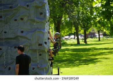 Fond Du Lac, Wisconsin USA - June 7th, 2019: Kids Of The Community Climb A Climbing Tower At Lakeside Park During Walleye Weekend That Is Setup By The Local United States Army Reserve. 