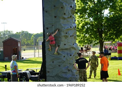 Fond Du Lac, Wisconsin USA - June 7th, 2019: Kids Of The Community Climb A Climbing Tower At Lakeside Park During Walleye Weekend That Is Setup By The Local United States Army Reserve. 