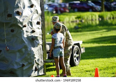 Fond Du Lac, Wisconsin USA - June 7th, 2019: Kids Of The Community Climb A Climbing Tower At Lakeside Park During Walleye Weekend That Is Setup By The Local United States Army Reserve. 