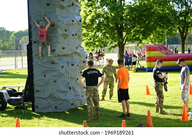 Fond Du Lac, Wisconsin USA - June 7th, 2019: Kids Of The Community Climb A Climbing Tower At Lakeside Park During Walleye Weekend That Is Setup By The Local United States Army Reserve. 