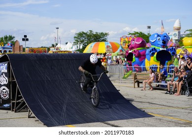 Fond Du Lac, Wisconsin USA - July 14th, 2019: Bicycle Stuntmen On BMX Doing Stunts On Half-pipe Ramps For A Crowd Of People At Fond Du Lac County Fair.   