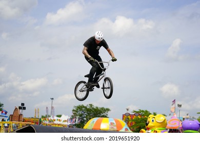 Fond Du Lac, Wisconsin USA - July 14th, 2019: Bicycle Stuntmen On BMX Doing Stunts On Half-pipe Ramps For A Crowd Of People At Fond Du Lac County Fair.