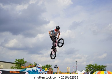 Fond Du Lac, Wisconsin USA - July 14th, 2019: Bicycle Stuntmen On BMX Doing Stunts On Half-pipe Ramps For A Crowd Of People At Fond Du Lac County Fair.