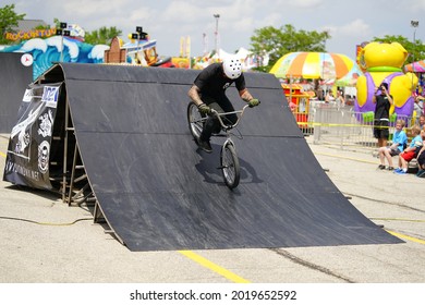 Fond Du Lac, Wisconsin USA - July 14th, 2019: Bicycle Stuntmen On BMX Doing Stunts On Half-pipe Ramps For A Crowd Of People At Fond Du Lac County Fair.