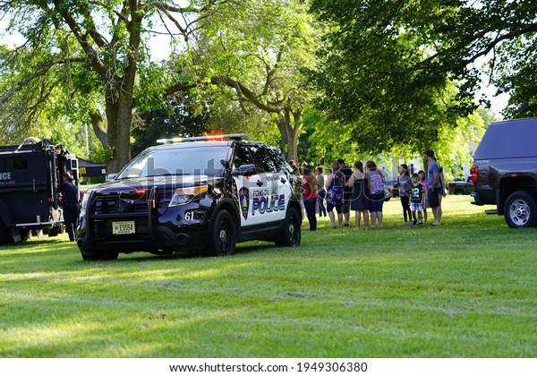 Fond du\
Lac, Wisconsin USA - June 20th, 2020: Community families and\
children enjoying themselves with local police officers and\
sheriffs during police officer appreciation\
day.